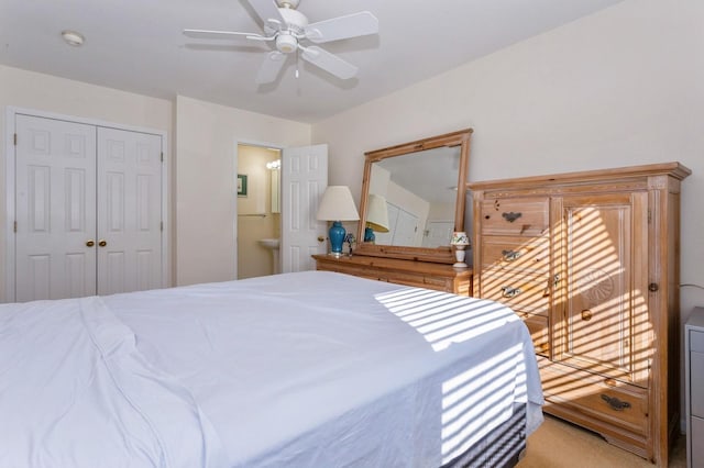 bedroom featuring ensuite bathroom, ceiling fan, and a closet