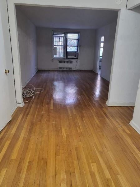 spare room featuring radiator heating unit and wood finished floors