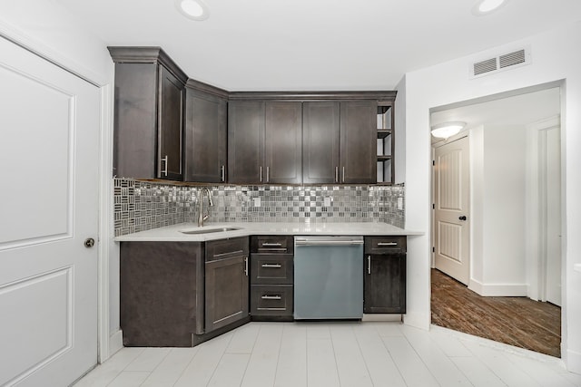 kitchen featuring sink, dark brown cabinets, and stainless steel dishwasher