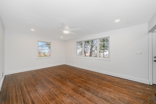 spare room with dark hardwood / wood-style floors and ceiling fan