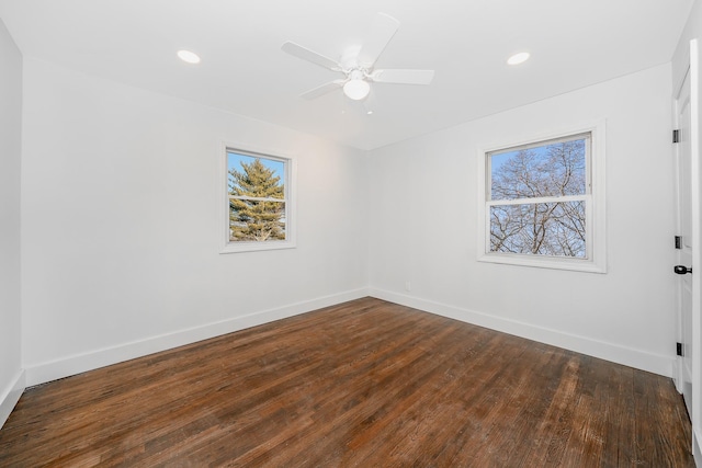 spare room with ceiling fan and dark hardwood / wood-style floors