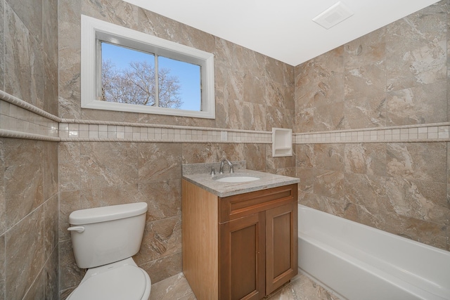 bathroom featuring toilet, vanity, a bath, and tile walls