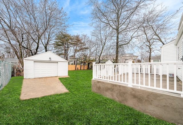 view of yard with an outbuilding, a garage, and a deck