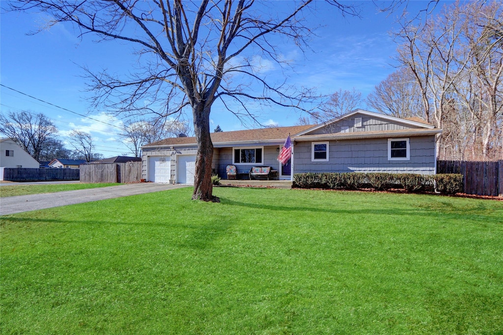 single story home with a garage and a front yard