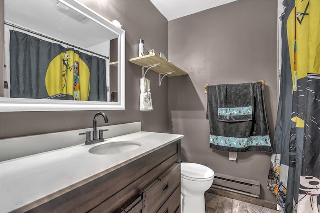 bathroom featuring vanity, a baseboard heating unit, wood-type flooring, and toilet