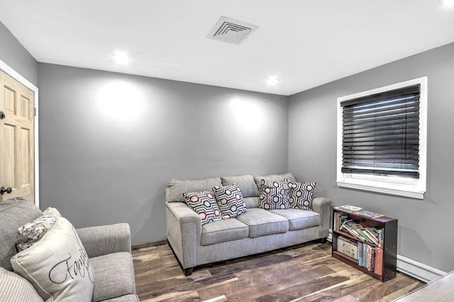 living room with dark hardwood / wood-style flooring