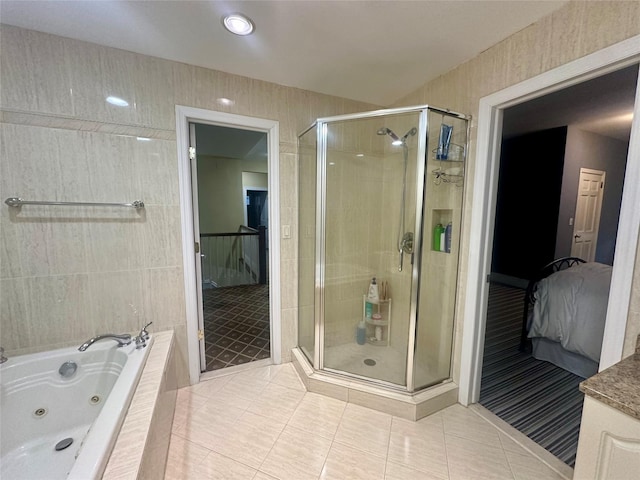 bathroom with shower with separate bathtub, tile walls, and tile patterned floors