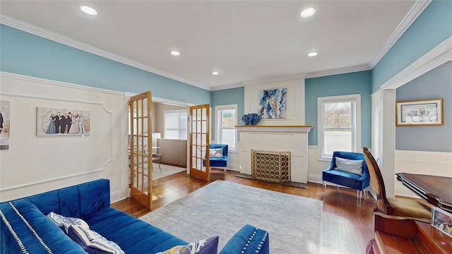 living room with a fireplace, crown molding, dark wood-type flooring, and french doors