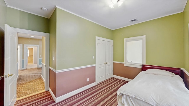 bedroom with ornamental molding and a closet