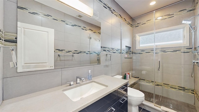 bathroom featuring tile walls, decorative backsplash, vanity, an enclosed shower, and toilet