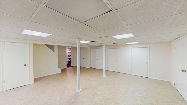 basement with a paneled ceiling