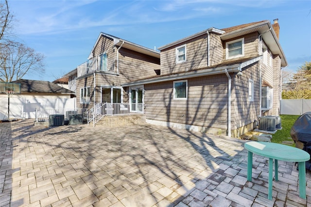 rear view of property featuring a patio and central AC unit