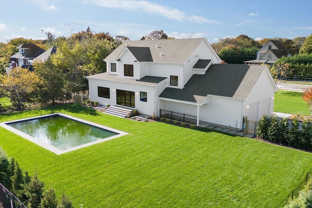 rear view of property featuring a lawn