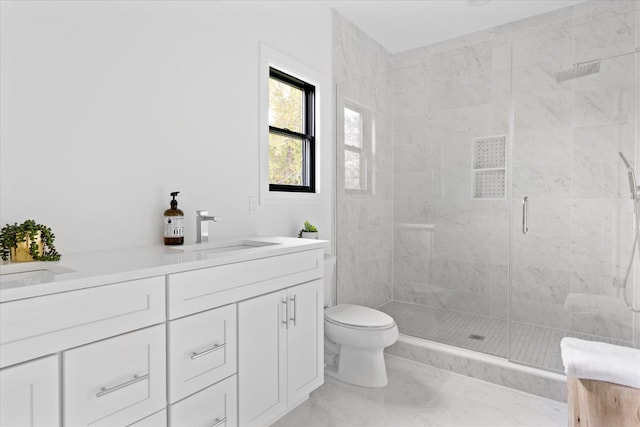 bathroom featuring vanity, a shower with door, and toilet