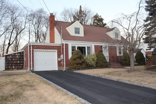 cape cod house with a garage and a front lawn