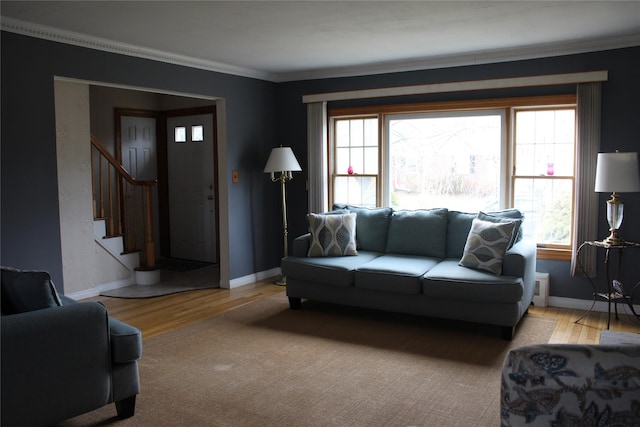 living room with light hardwood / wood-style flooring and ornamental molding