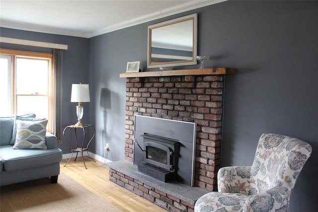 living area featuring crown molding and hardwood / wood-style floors