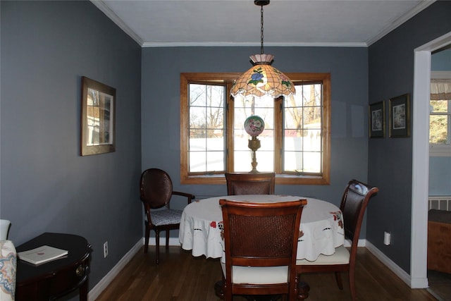 dining space featuring dark hardwood / wood-style flooring and crown molding