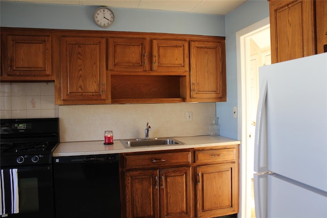 kitchen with sink, decorative backsplash, and black appliances