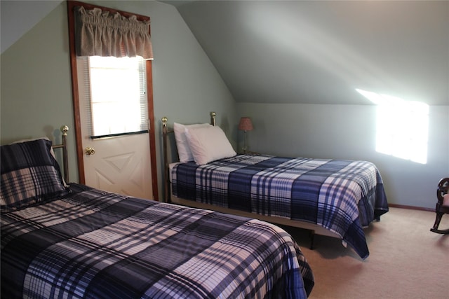 bedroom featuring lofted ceiling and carpet floors