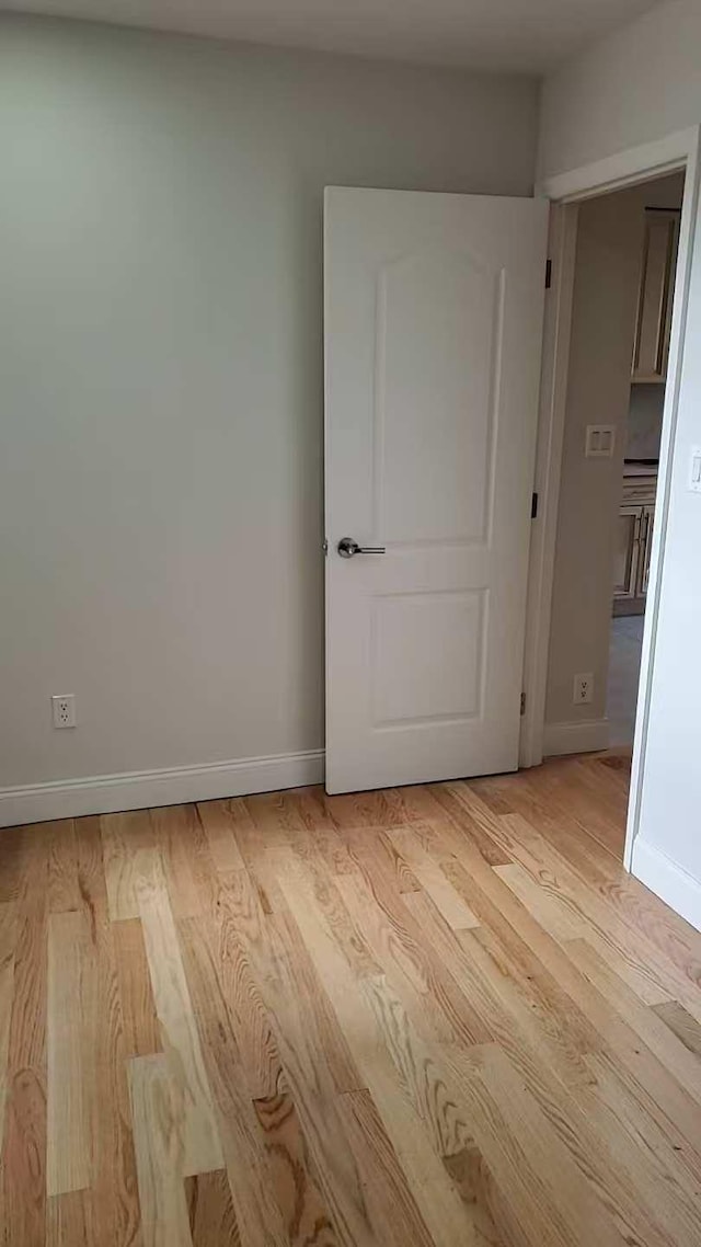 spare room with light hardwood / wood-style floors