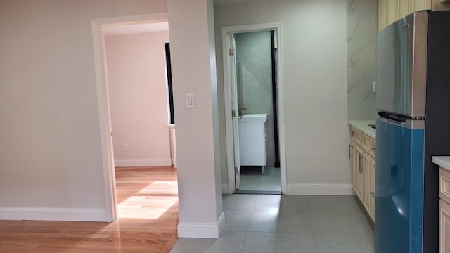 bathroom featuring wood finished floors, vanity, and baseboards