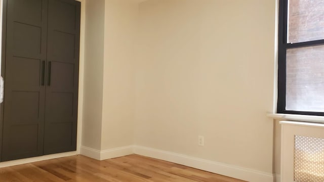 spare room with light wood-style flooring and baseboards