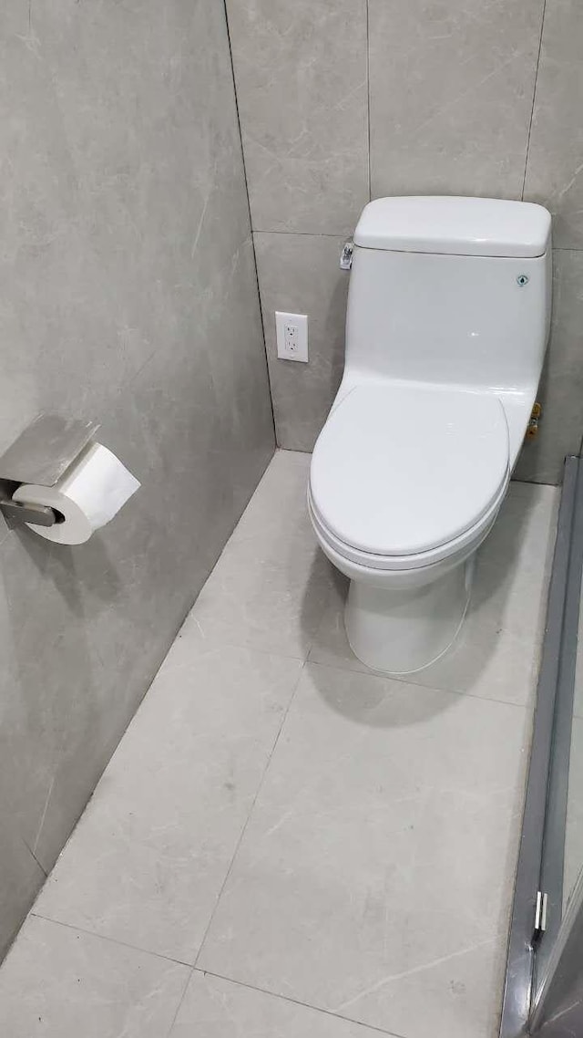 bathroom featuring toilet and tile patterned flooring