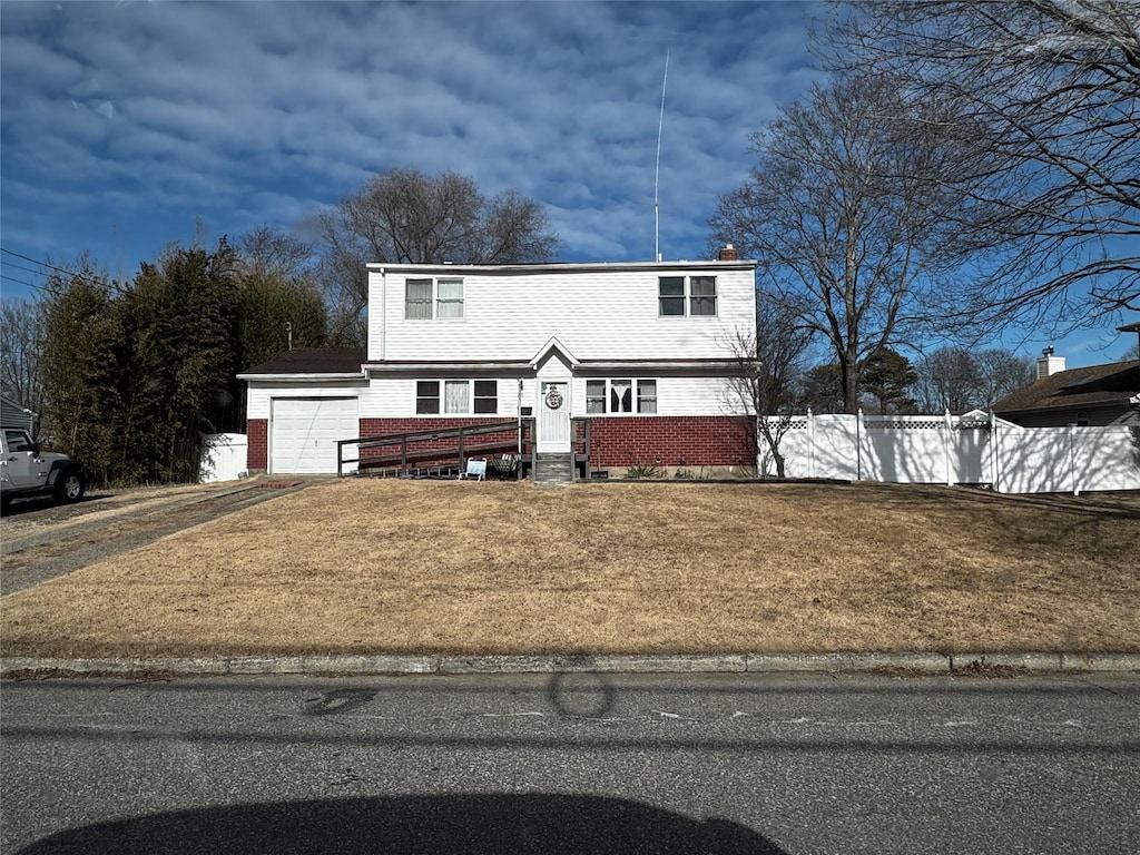 view of front of home with a garage and a front yard