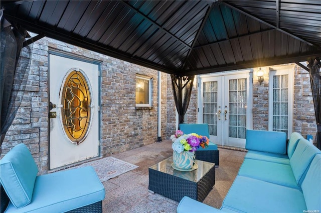 view of patio with french doors, an outdoor living space, and a gazebo