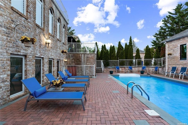 view of swimming pool featuring a patio area