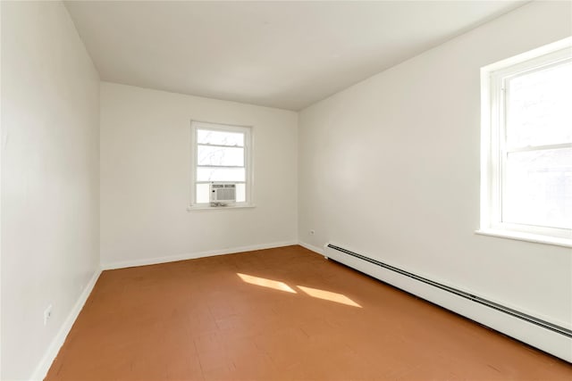 unfurnished room with a baseboard radiator, baseboards, and cooling unit