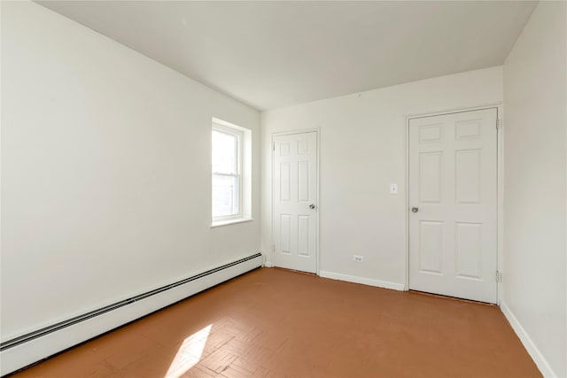 spare room featuring a baseboard radiator and baseboards