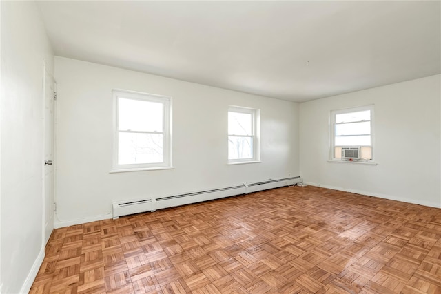 spare room with a baseboard heating unit, cooling unit, and baseboards