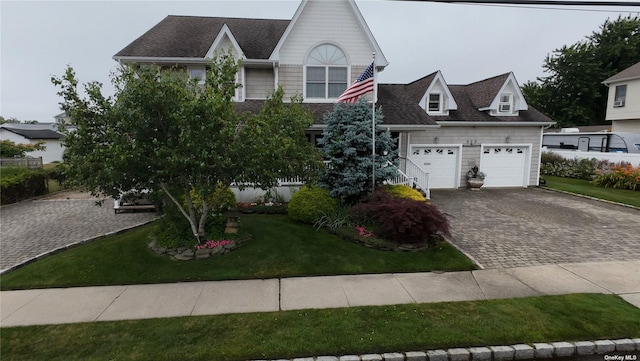 view of front of property featuring a garage and a front yard