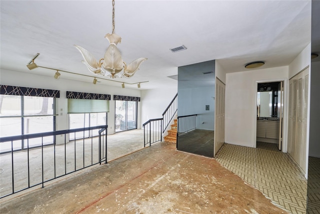 spare room featuring a chandelier