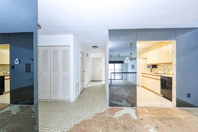 kitchen featuring sink, black dishwasher, tasteful backsplash, and white refrigerator