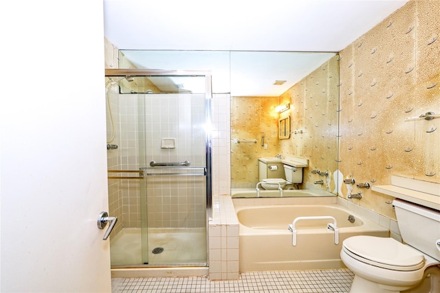 bathroom featuring shower with separate bathtub, toilet, and tile patterned floors