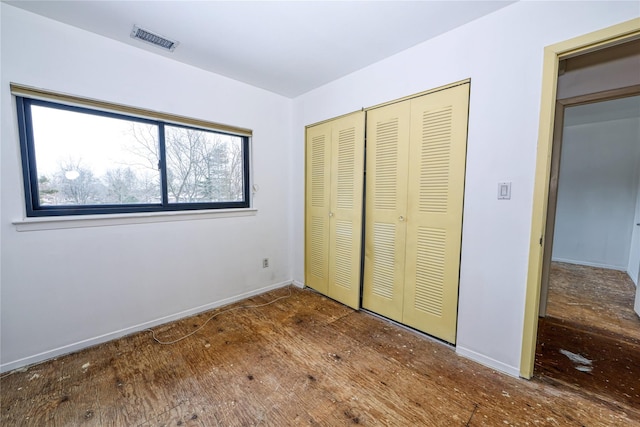 unfurnished bedroom featuring a closet and wood-type flooring