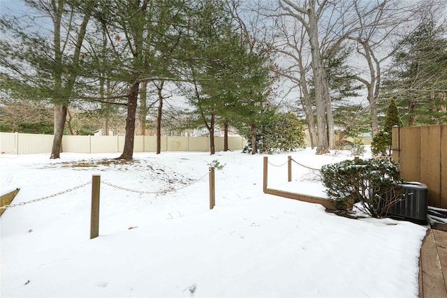 snowy yard featuring central AC unit