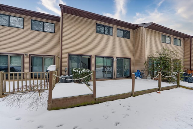 view of snow covered rear of property