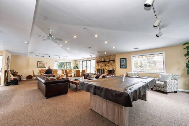 game room featuring billiards, rail lighting, light colored carpet, and a fireplace