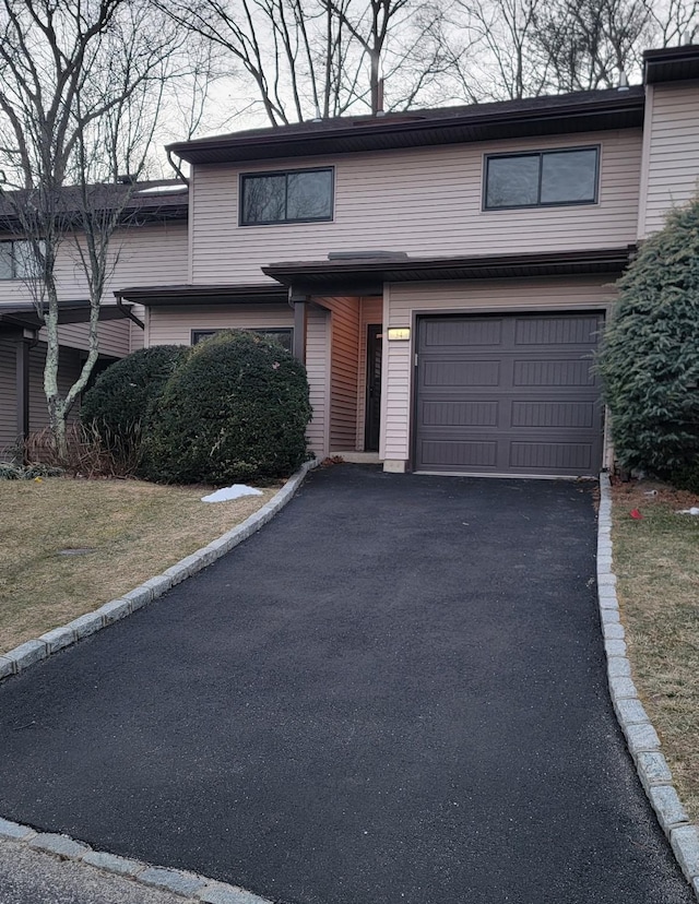 view of front facade with a front yard and a garage