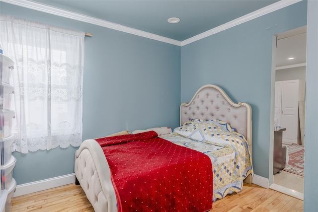 bedroom with hardwood / wood-style floors and crown molding