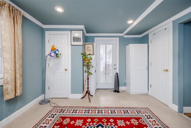 tiled foyer entrance with ornamental molding