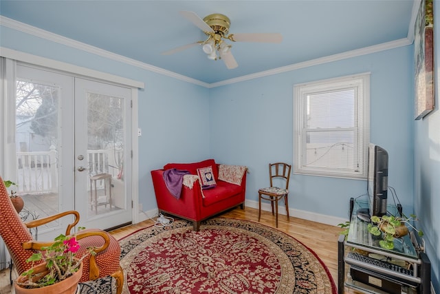 living area with french doors, ornamental molding, wood-type flooring, and ceiling fan