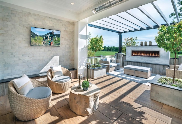 view of patio / terrace featuring an outdoor living space with a fireplace and a pergola