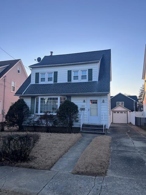 view of front facade featuring a garage and an outdoor structure