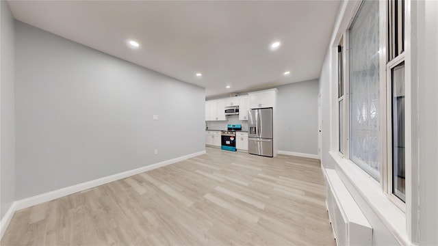 unfurnished living room with light hardwood / wood-style floors