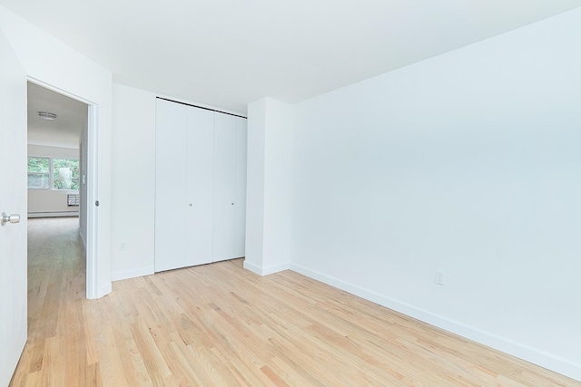 unfurnished bedroom featuring a closet and light wood-type flooring